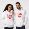 A couple wearing matching white customized name printed couple hoodies set with red heart design, personalized his and her hoodie set.