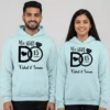 Personalized 15th anniversary couple hoodies with “We Still Do” design in light blue worn by a smiling couple.