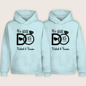 Light blue personalized 15th anniversary couple hoodies with “We Still Do 15 Years” design and custom names.