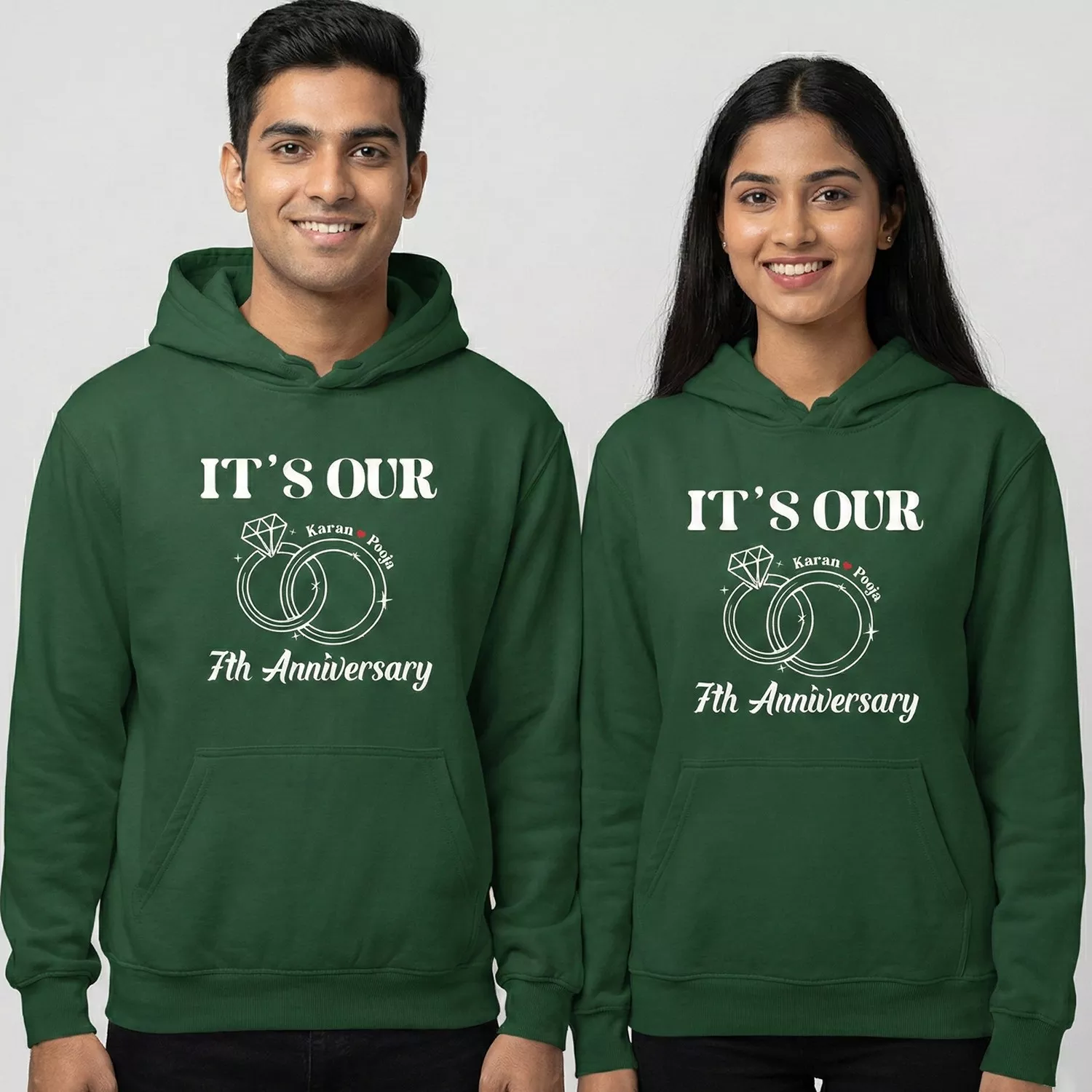 Couple wearing personalized 7th anniversary couple hoodies in green with custom names and ring design