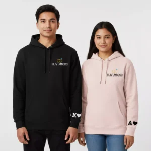 Couple wearing personalized hoodies with Roman date on the chest and initials on the sleeve in black and pink colors