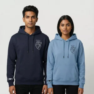 Couple wearing anatomical heart hoodies with personalized sleeve initials – personalized crown design hoodies