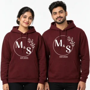 Maroon personalized couple hoodies with white M and S initials, circular botanical detail, and EST. 2025 text.