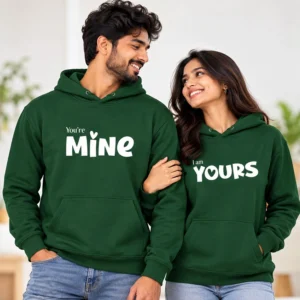Personalized matching couple hoodies in dark green with white “You’re Mine” and “I am Yours” designs worn by an Indian couple