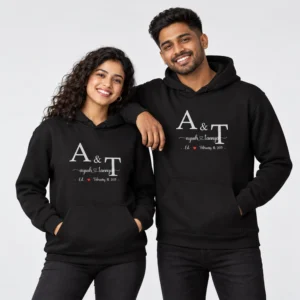 Black personalized couple hoodies with large A and T initials, Ayush and Tannya names, a red heart, and February 14 2013 date.