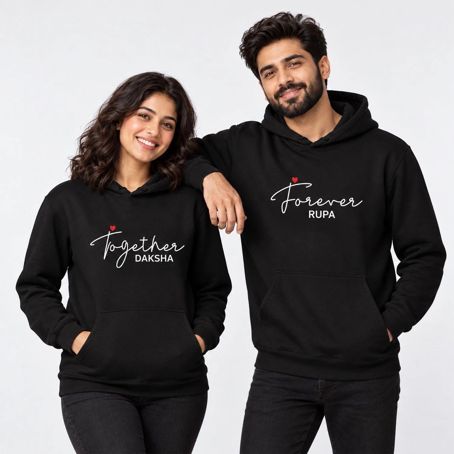 Black personalized couple hoodies with Together Daksha and Forever Rupa text in white script with small red hearts.