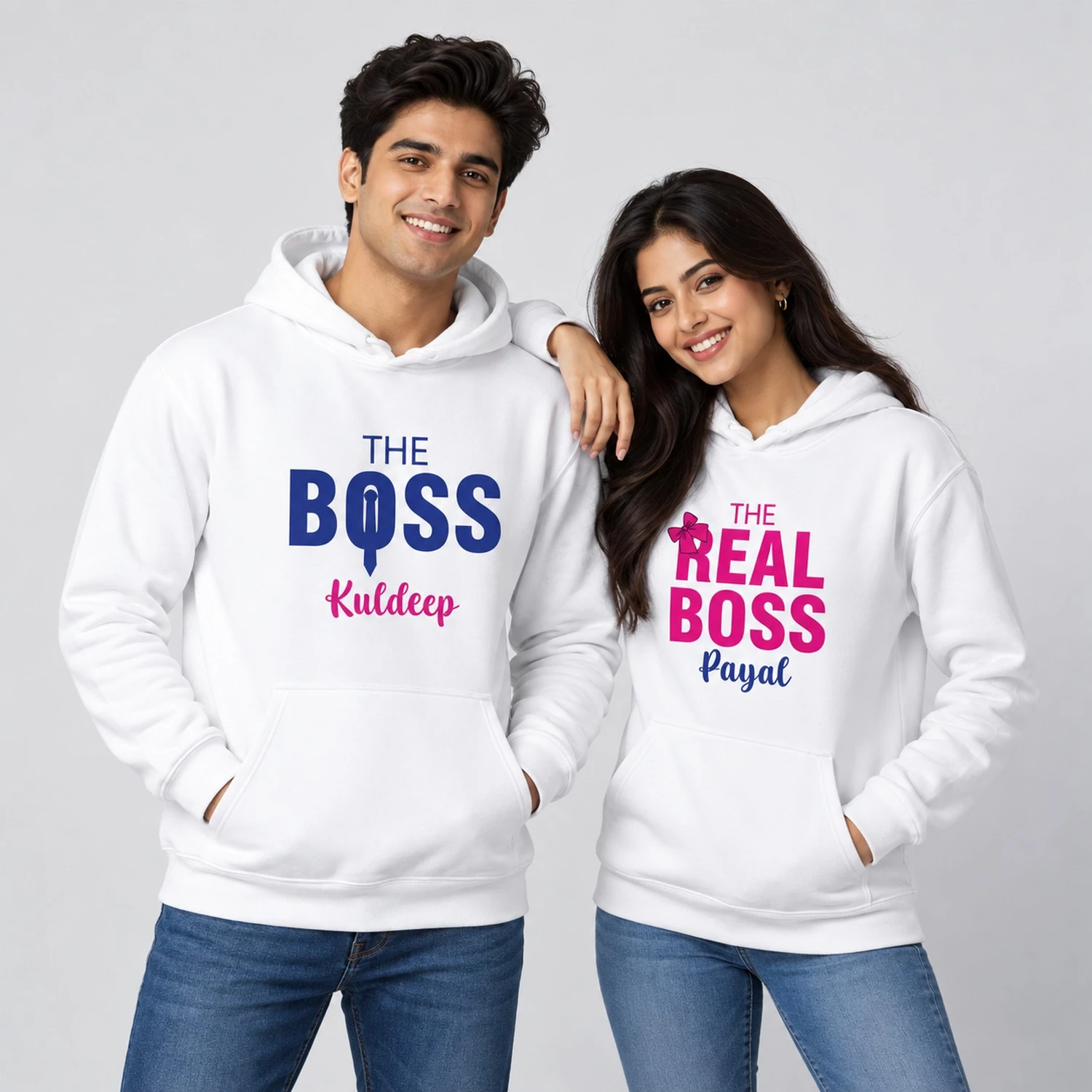 White personalized couple hoodies with The Boss Kuldeep and The Real Boss Payal typography in blue and pink.