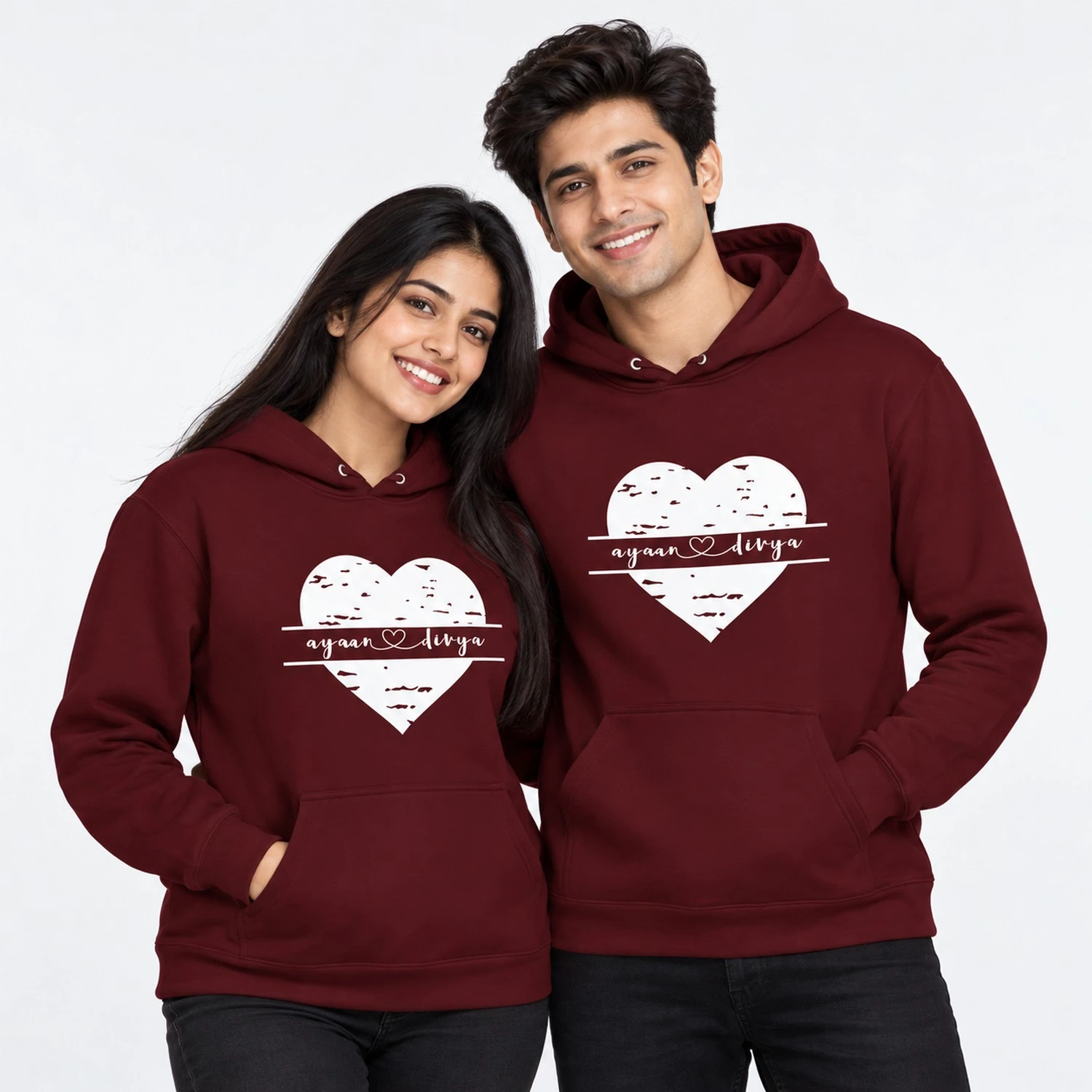 Personalized name printed couple hoodies in maroon with a distressed white heart design and Ayaan and Divya names joined by a heart.
