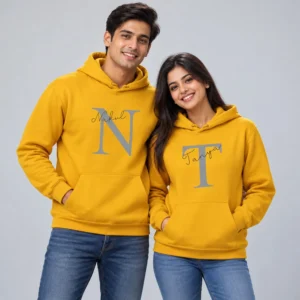 Personalized name printed couple hoodies in mustard yellow with large N and T initials and the names Nakul and Tanya.