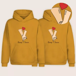 Mustard yellow personalized name design couple hoodies with hand-holding illustration and custom names printed on sleeves