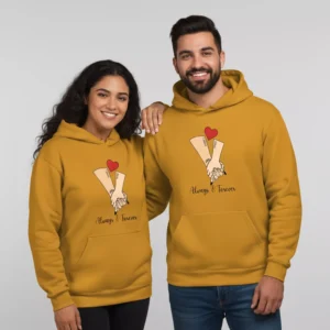 Couple wearing mustard yellow personalized name design couple hoodies with matching hand-holding artwork and heart graphic