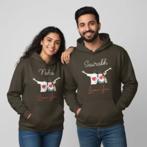 A smiling Indian couple wearing personalized name hoodies for couples with heart designs, showcasing custom couple hoodie set.