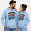 Couple wearing matching light blue personalized hoodies with a “Your Year Together” custom anniversary design.