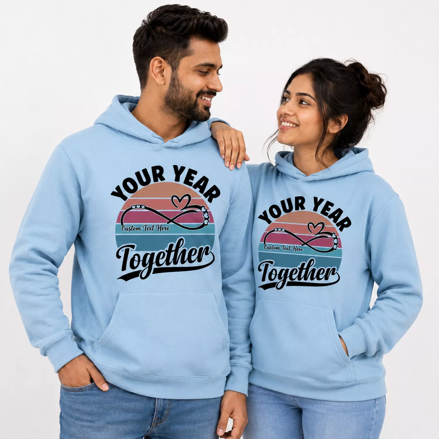 Couple wearing matching light blue personalized hoodies with a “Your Year Together” custom anniversary design.