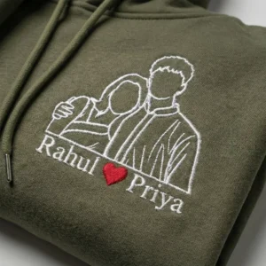 Close-up view of personalized photo-to-line-art embroidery on couple hoodie with custom names