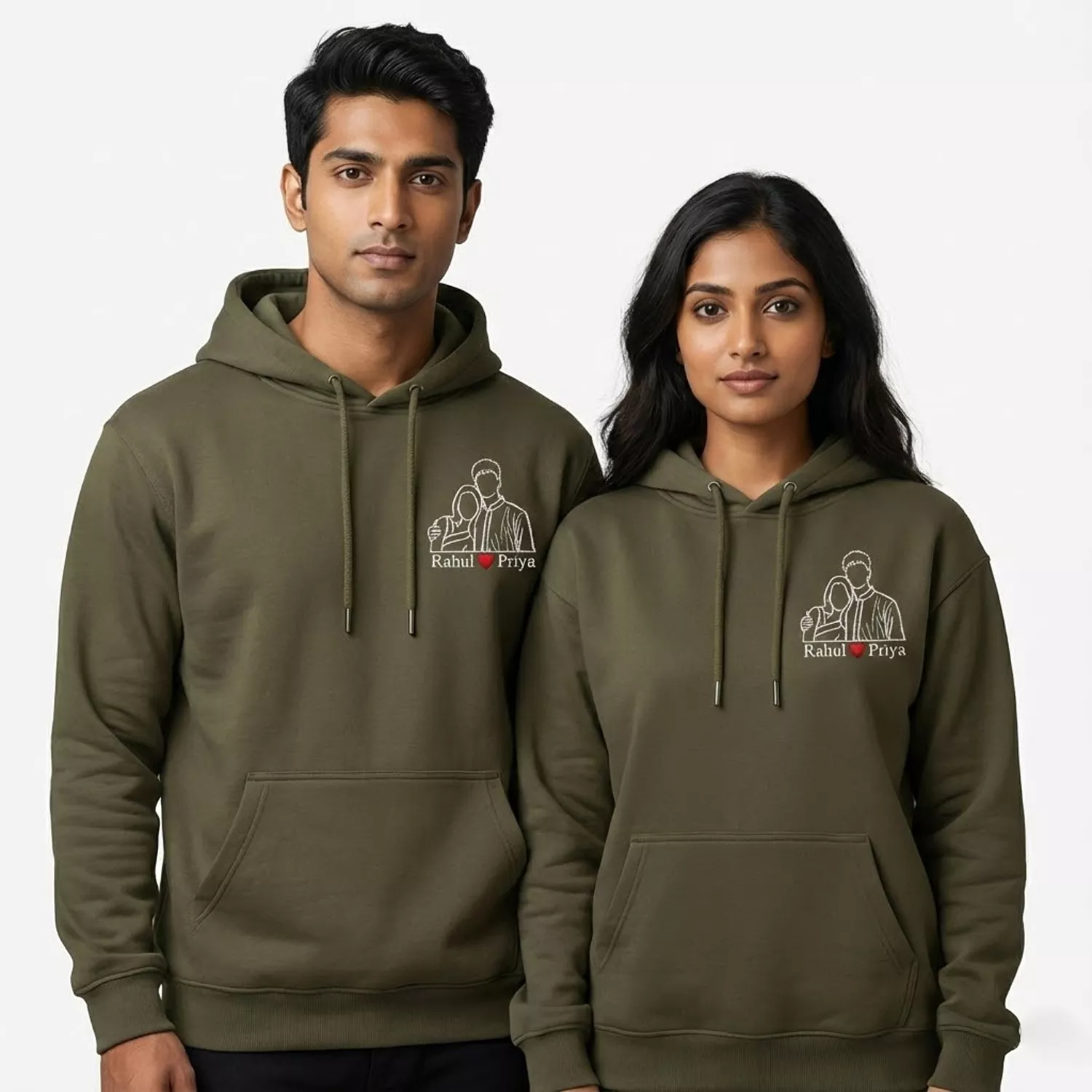 Couple wearing personalized hoodies with custom photo-to-line-art embroidery and names on the chest