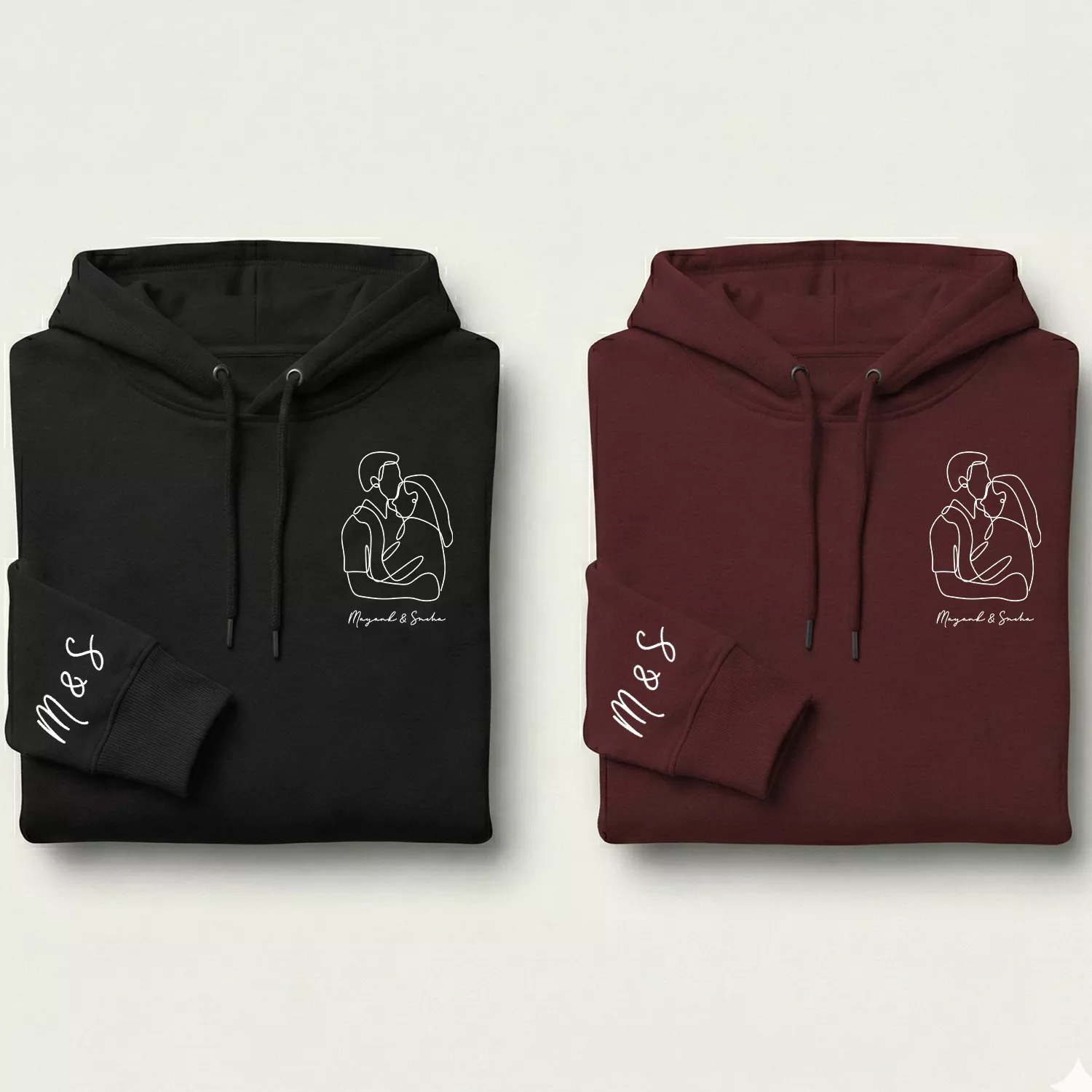 Premium sleeve initials couple hoodie set in black and maroon with minimal line-art couple design and custom initials