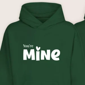 Close-up view of green “You’re Mine” couple hoodie with white printed text