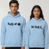 Couple wearing light blue matching hoodies with “You’re My Sun” and “I’m Your Moon” printed in black text