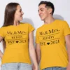 Newly married couple wearing personalized Mr and Mrs wedding matching T-shirts with surname print