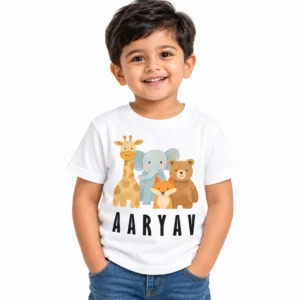 Smiling toddler boy wearing a white personalized kids T-shirt featuring cartoon giraffe, elephant, fox and bear illustrations with the name AARYAV in bold black uppercase letters.