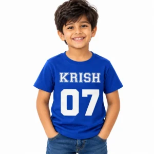 Smiling young boy wearing a royal blue personalized kids T-shirt featuring the name KRISH in white varsity-style letters above a large white number 07.