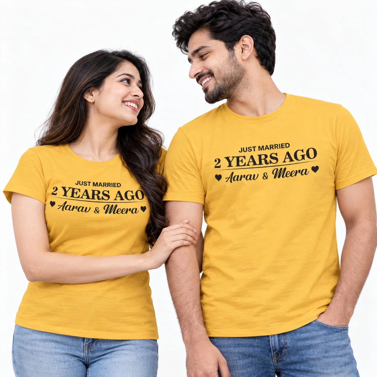 Couple wearing matching yellow Just Married 2 Years Ago T-shirts featuring black lettering, Aarav and Meera names and small heart symbols.