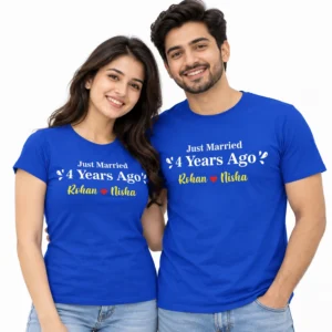 Couple wearing royal blue matching anniversary T-shirts printed with Just Married 4 Years Ago and the names Rohan and Nisha in yellow lettering with a red heart.