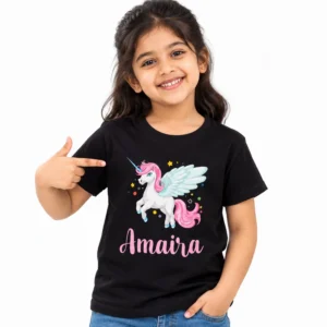 Young girl wearing a black personalized unicorn T-shirt featuring a white winged unicorn with pink mane, blue wings, colorful stars, and custom name Amaira in pink script.