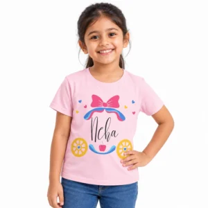 Smiling young girl wearing a light pink personalized T-shirt featuring the name Neha in black cursive lettering with a pink bow, colorful hearts, and princess carriage design.