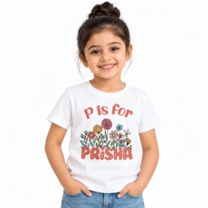 Young girl wearing a white personalized T-shirt featuring P is for Prisha lettering with colorful illustrated flowers in pink, yellow, blue, and orange.