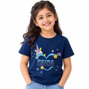 Young girl wearing a navy blue personalized kids T-shirt featuring a colorful unicorn, blue heart outline, yellow and pink stars, and custom name MAIRA.