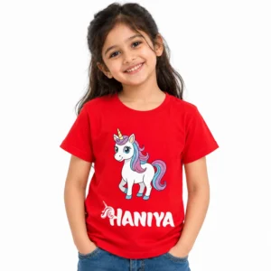 Young girl wearing a red personalized kids T-shirt featuring a white cartoon unicorn with pink and blue mane, colorful tail, and bold white custom name HANIYA.