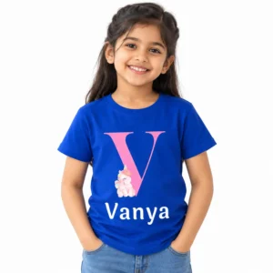 Young girl wearing a royal blue personalized kids T-shirt featuring a large pink letter V, small pastel unicorn illustration, and white custom name Vanya.