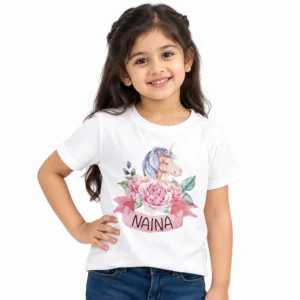 Young girl wearing a white personalized unicorn T-shirt featuring pastel pink flowers, a watercolor unicorn with blue mane, and custom name NAINA on a pink ribbon.