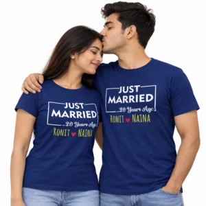 Indian couple wearing matching navy blue Just Married T-shirts featuring white rectangular lettering, 20 Years Ago text, and Ronit and Naina names separated by a red heart.
