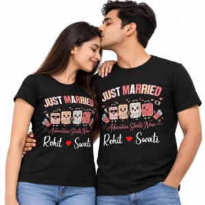 Indian couple wearing matching black Just Married T-shirts featuring colorful cartoon suitcases, Adventure Starts Now lettering, and Rohit and Swati names with a red heart.