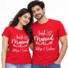 Indian couple wearing matching red personalized Just Married T-shirts with white wedding ring artwork and Aditya & Sneha names.
