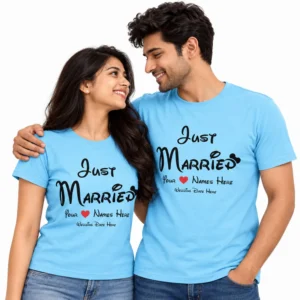 Indian couple wearing matching sky blue Just Married T-shirts with black lettering, a red heart, customizable names and wedding date placeholders.