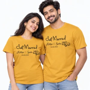 Couple wearing matching mustard yellow Just Married T-shirts with Aditya and Sneha names, wedding date 26.04.2026 and a vintage wedding car illustration.