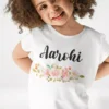 White cotton kids T shirt with custom name Aarohi printed above soft floral design
