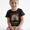 Girl wearing black personalized kids name T shirt with colorful rainbow print and custom name