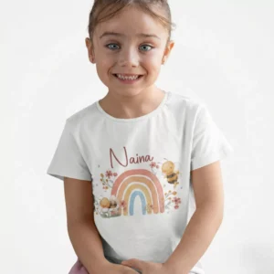 Child wearing personalized cotton kids name T shirt with custom rainbow print design for birthday celebration