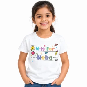 Young girl wearing a white personalized kids T-shirt with colorful N is for Neha lettering, school-themed illustrations, stars, pencil, apple and light bulb graphics.