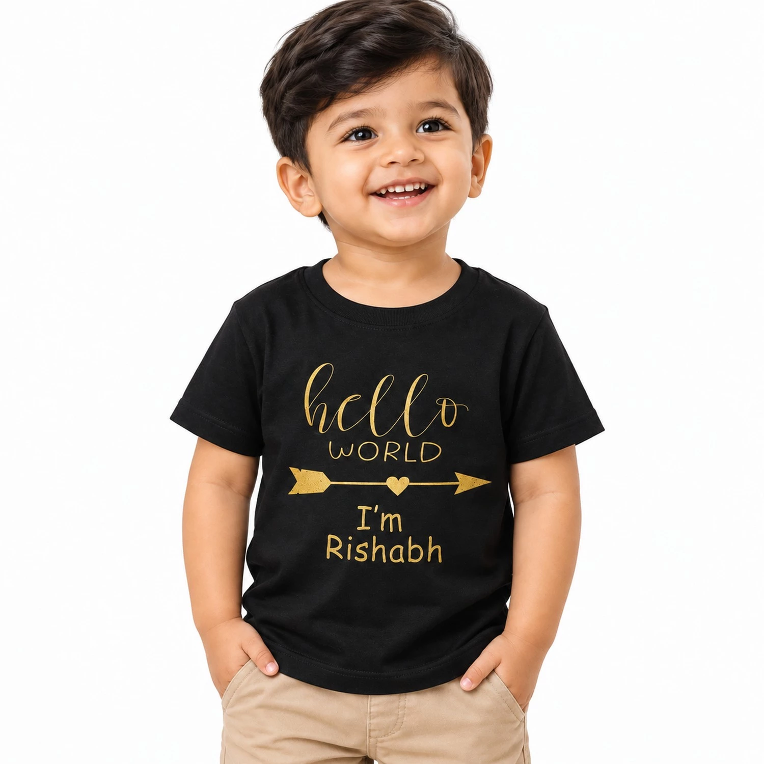 Smiling little boy wearing a black personalized kids T-shirt featuring gold Hello World lettering, a heart arrow design, and the custom name Rishabh.