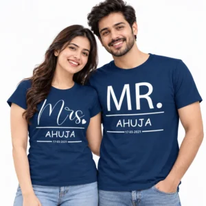 Indian couple wearing navy blue personalized T-shirts with white Mrs. and MR. prints, AHUJA surname, and date 17-03-2021.
