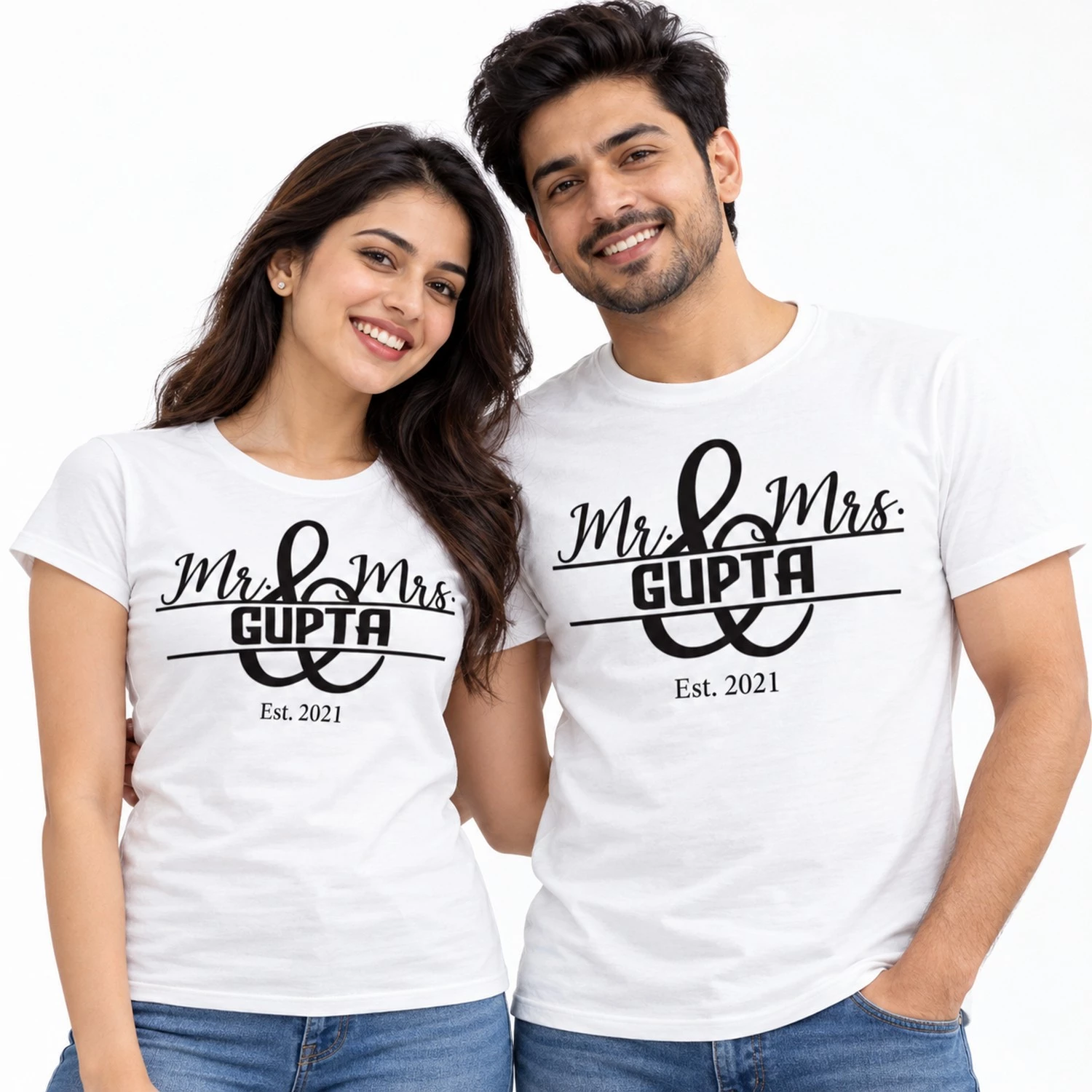 Indian couple wearing matching white Mr. and Mrs. Gupta T-shirts with black ampersand artwork, personalized surname, and Est. 2021 lettering.