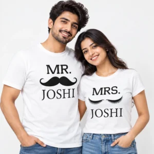 Indian couple wearing matching white personalized couple T-shirts with black MR. JOSHI mustache artwork on the men's shirt and MRS. JOSHI eyelash artwork on the women's shirt.