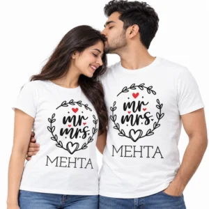 Indian couple wearing matching white Mr. and Mrs. Mehta T-shirts with black leafy wreath artwork, red hearts, and personalized surname lettering.