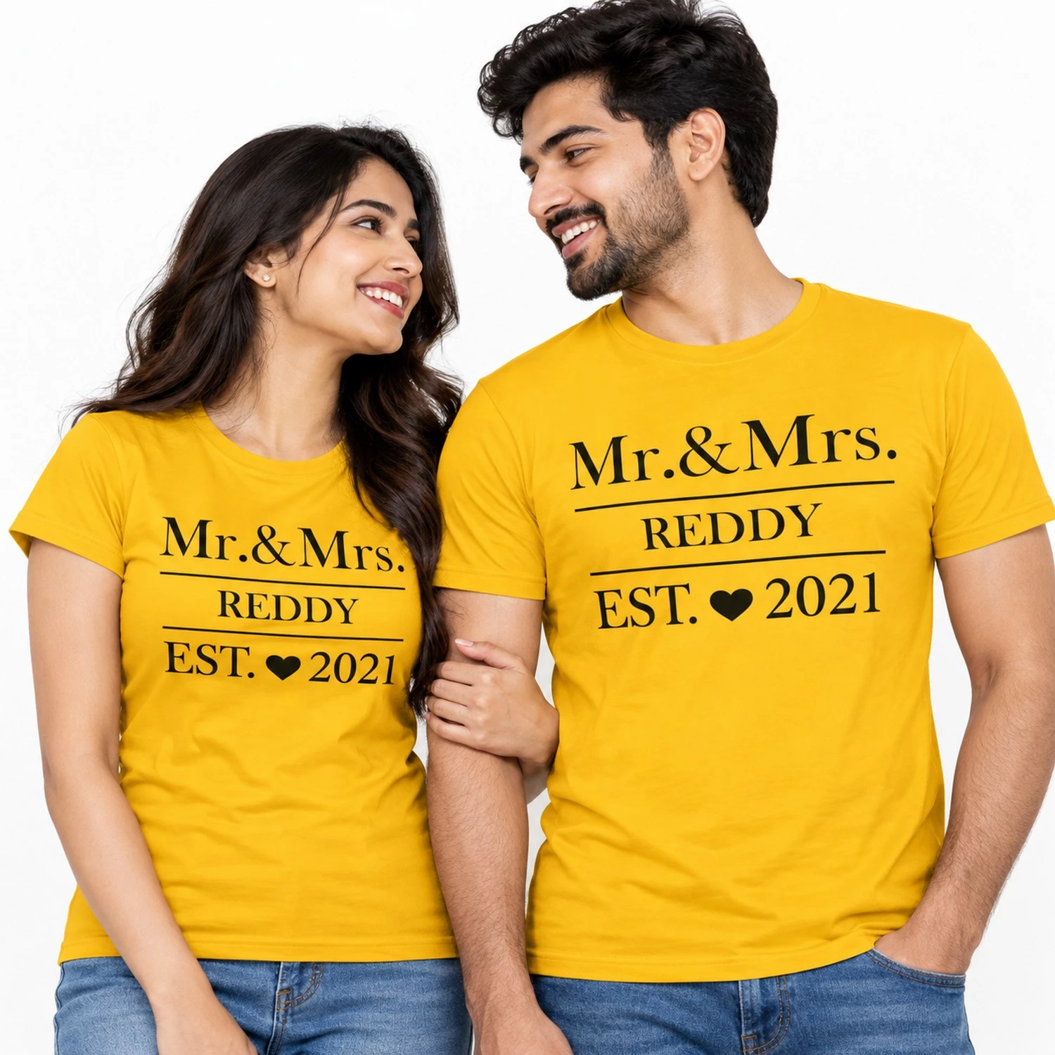 Indian couple wearing matching yellow Mr. and Mrs. Reddy T-shirts with bold black lettering, heart illustration, and EST. 2021 print.